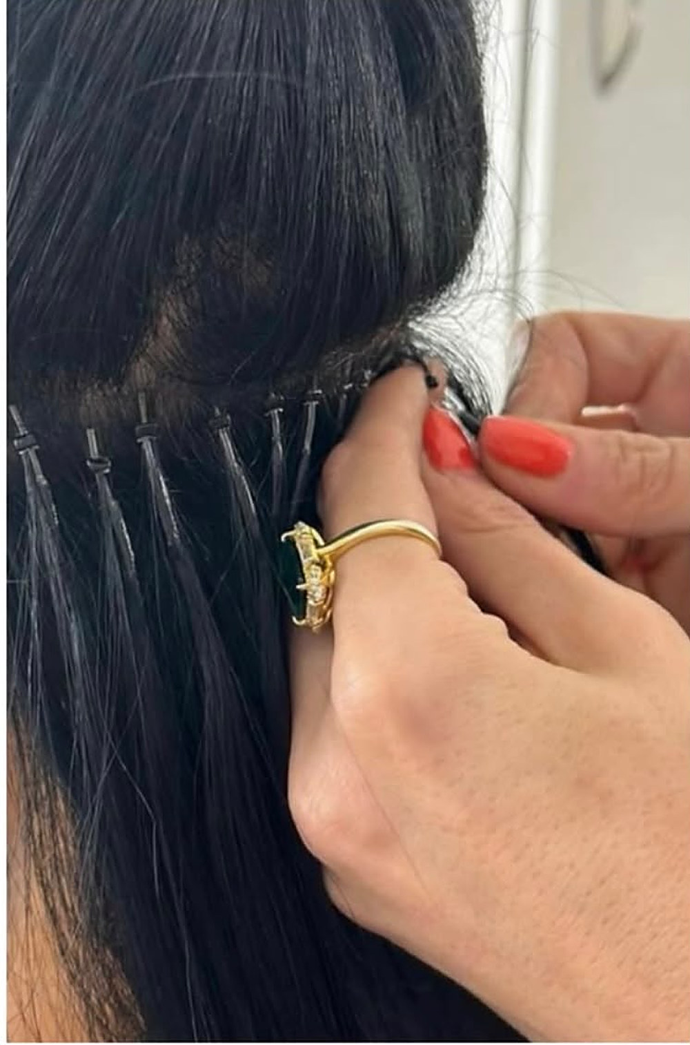 Close-up of extensions being applied at the root